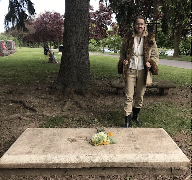 image of woman standing next to grave